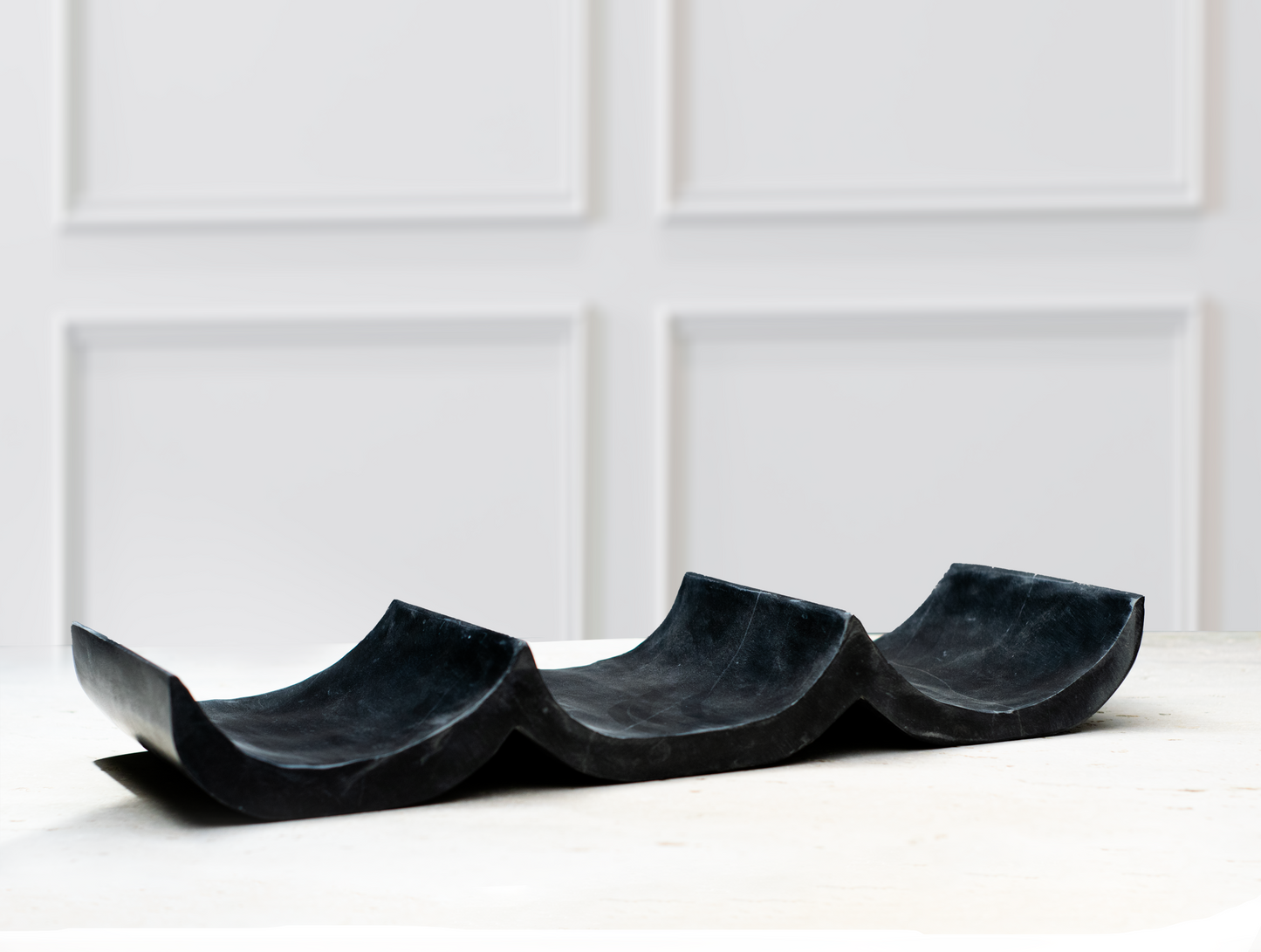 Premium marble wine holder showcasing three wine bottles in a modern dining room.