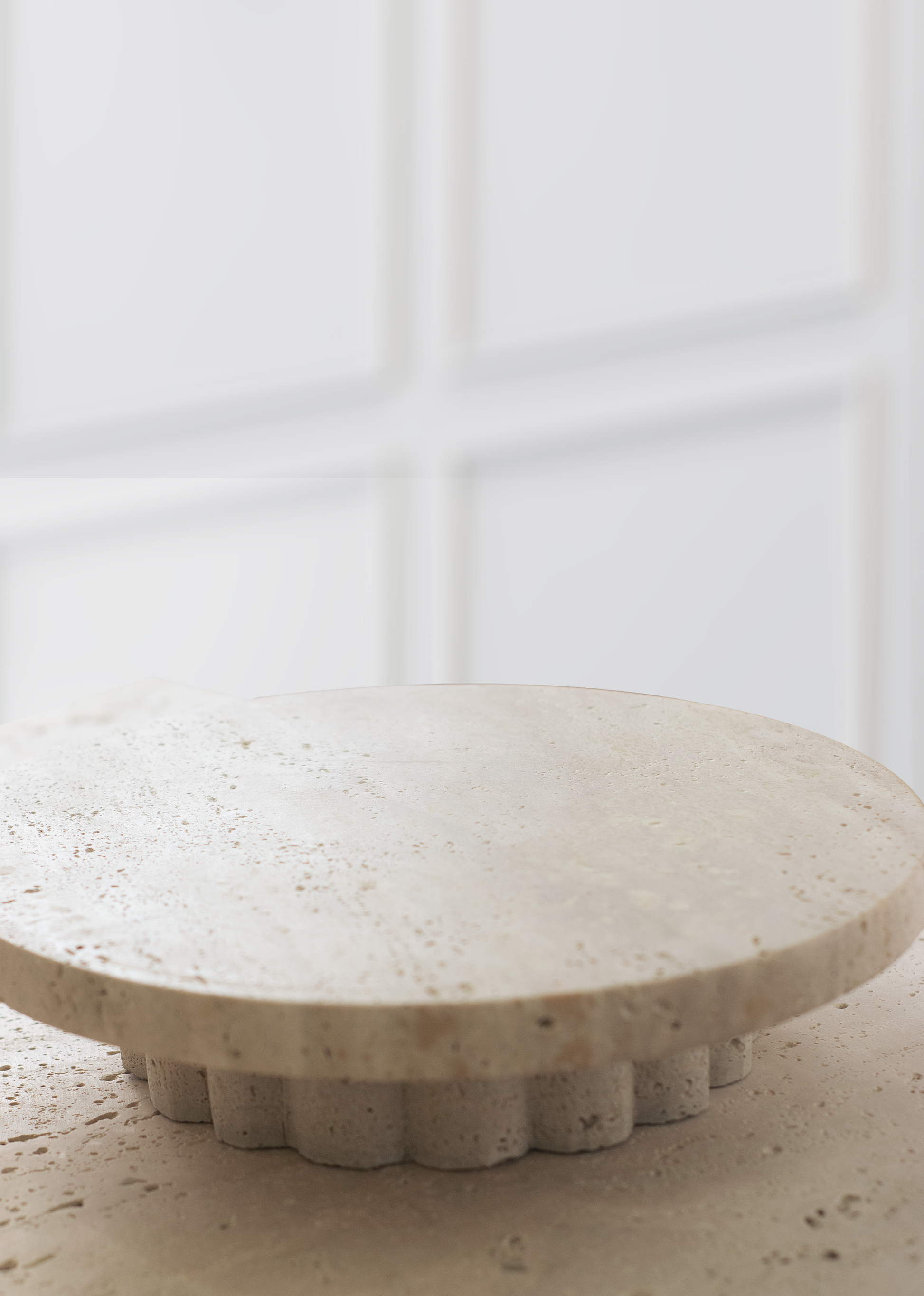 Handcrafted round décor tray in natural travertine, featuring unique textures and earthy tones for stylish home decor.