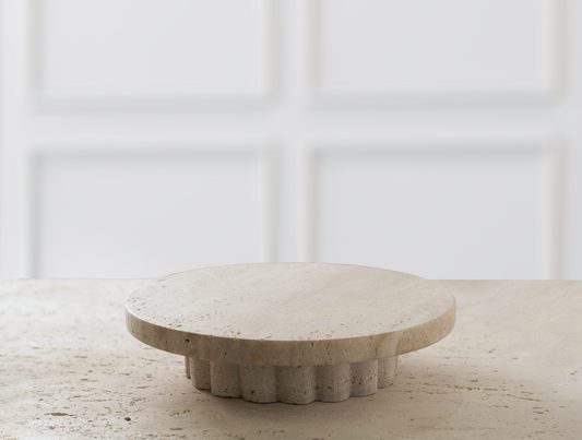 Beautiful round decorative tray made from natural travertine, showcasing the stone's unique veining and warm color palette.