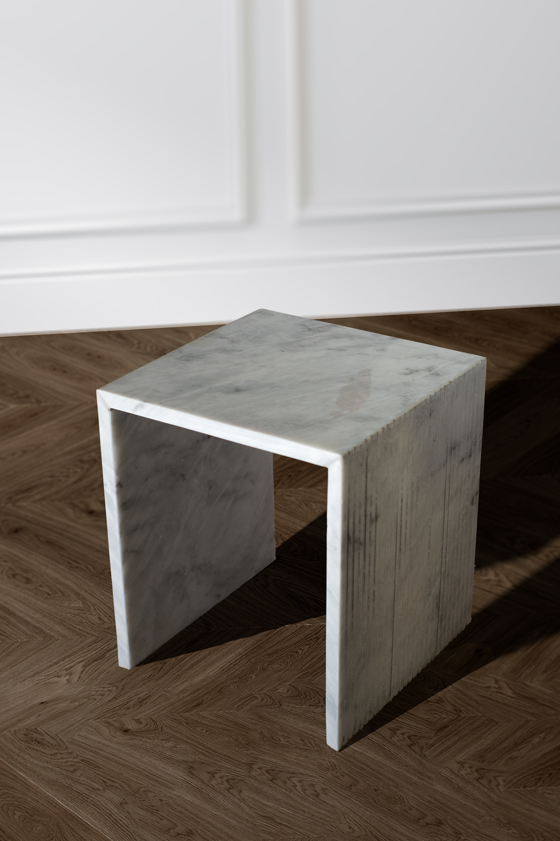 Unique white marble side table highlighting its minimalist design and sophisticated aesthetics.