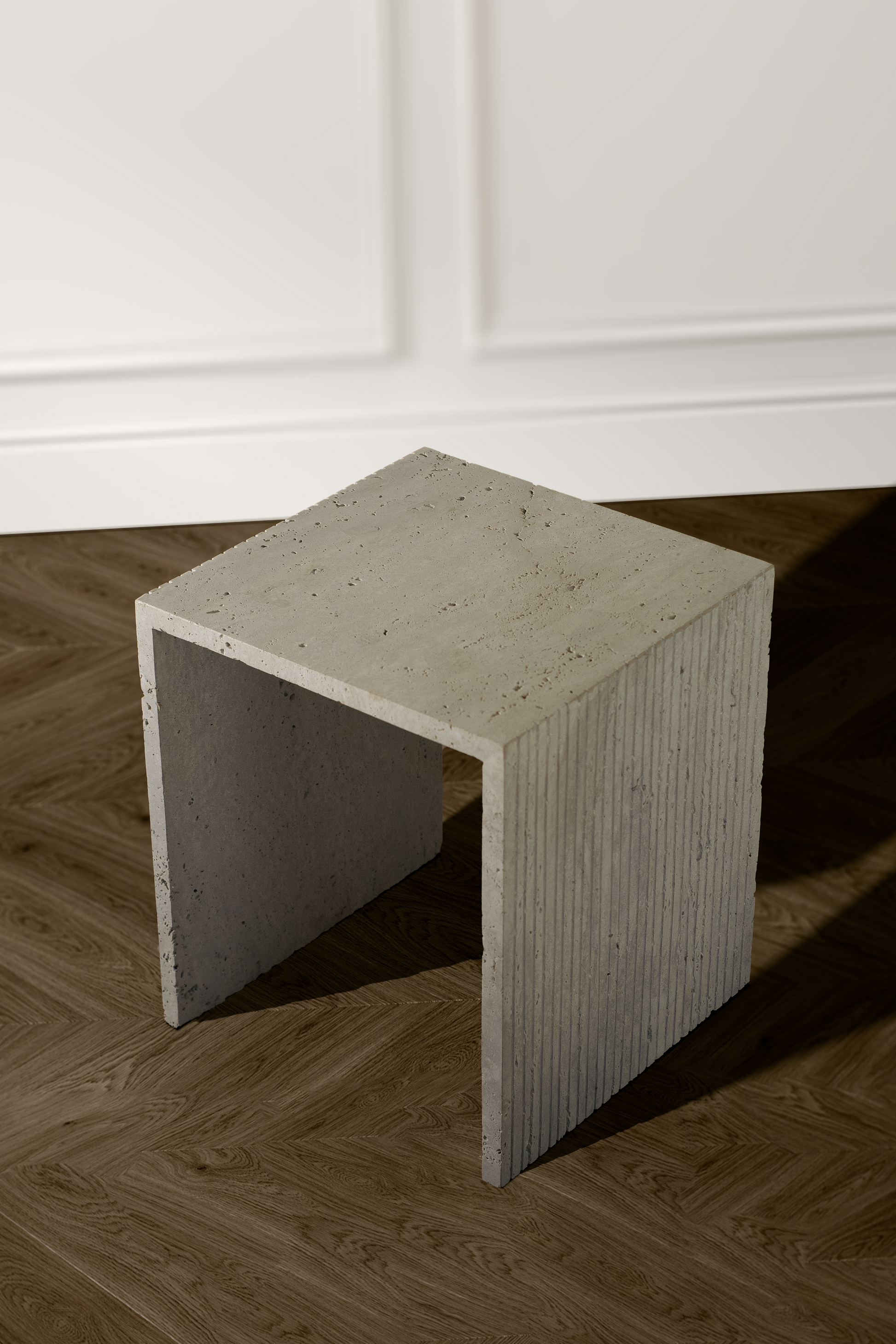 Handcrafted travertine side table showcasing its smooth, polished surface and natural variations.
