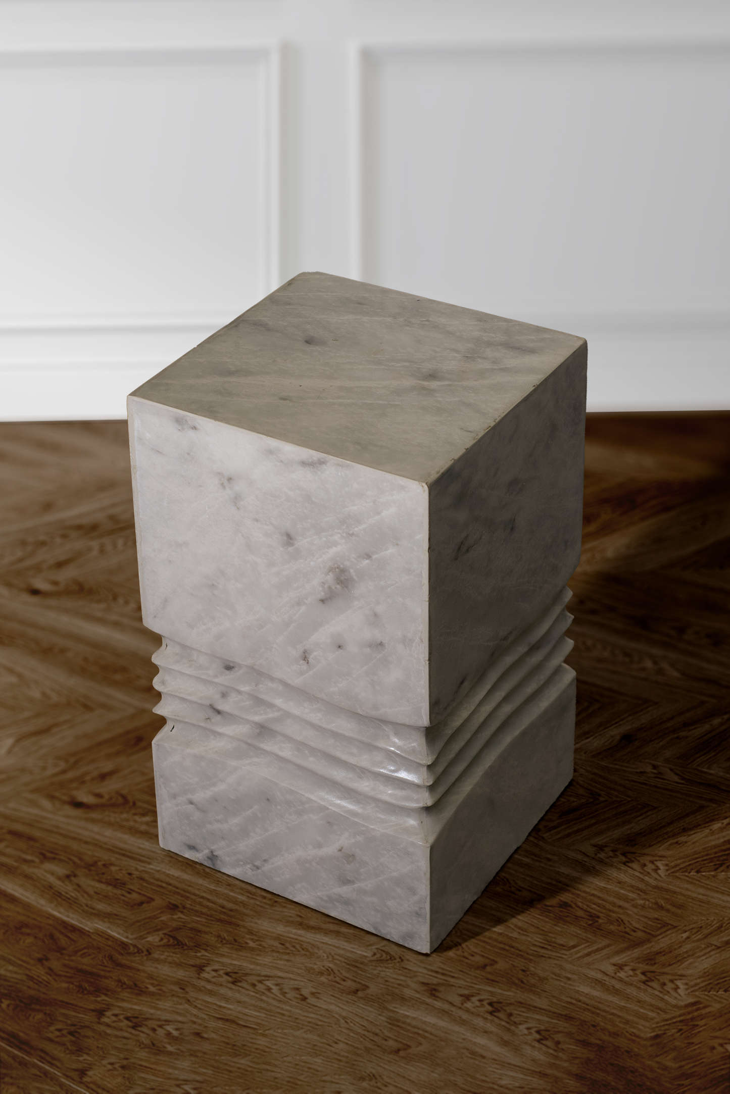 Elysian side table in white marble displayed in a modern living room setting.