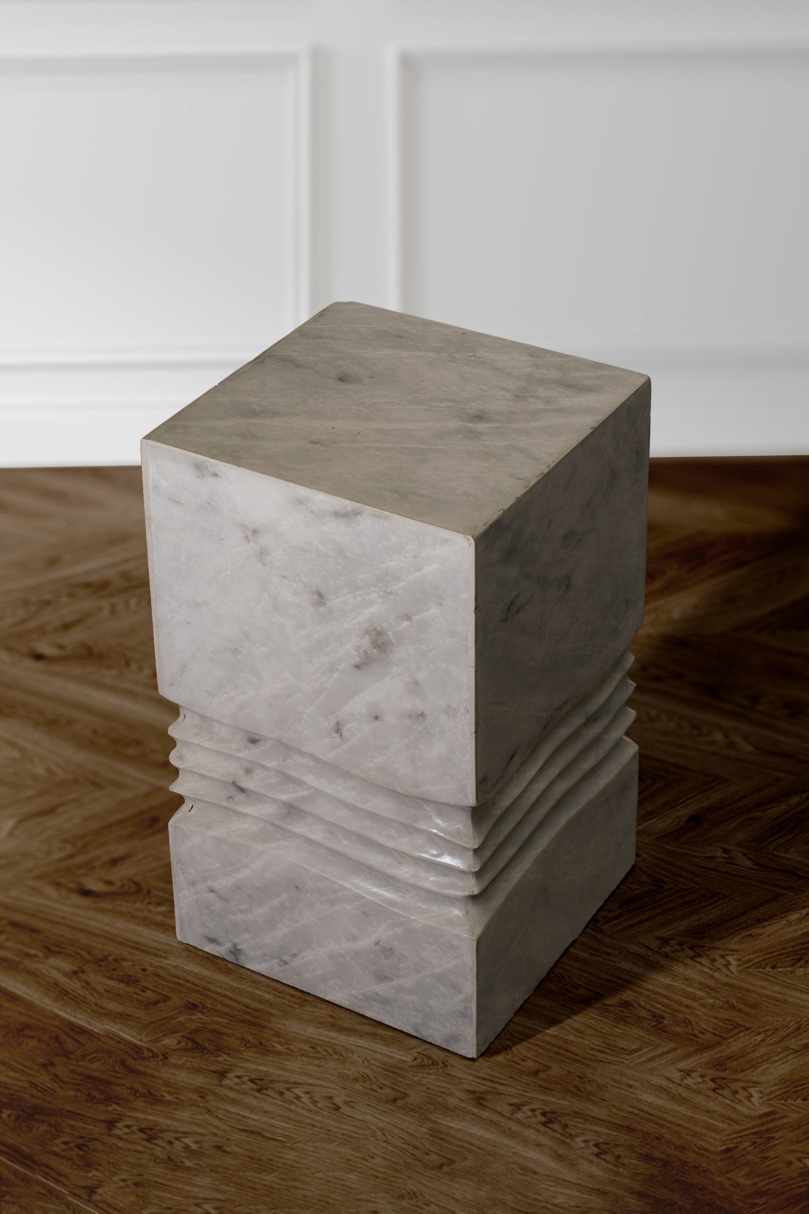 Elysian side table in white marble displayed in a modern living room setting.