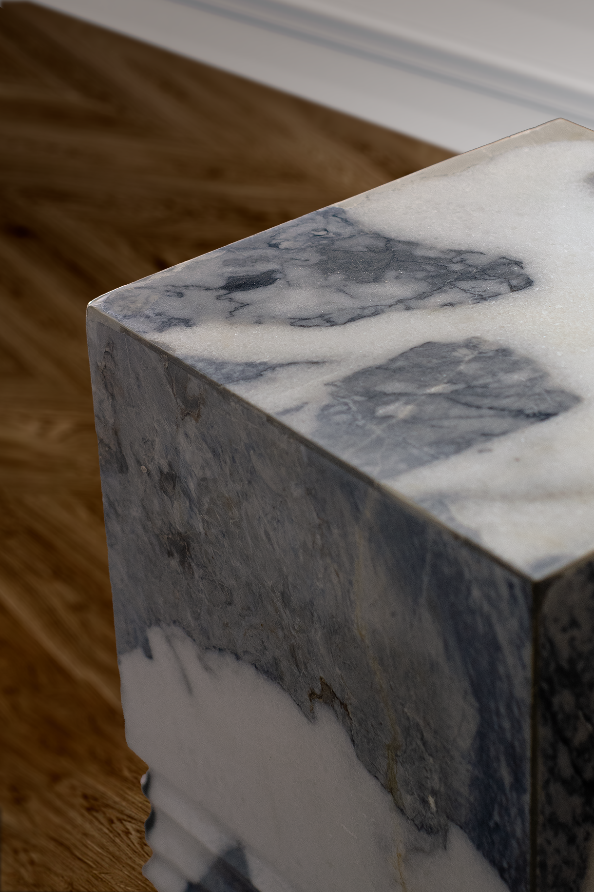 Unique marble side table with sculpted base and smooth top, adding sophistication to a space.