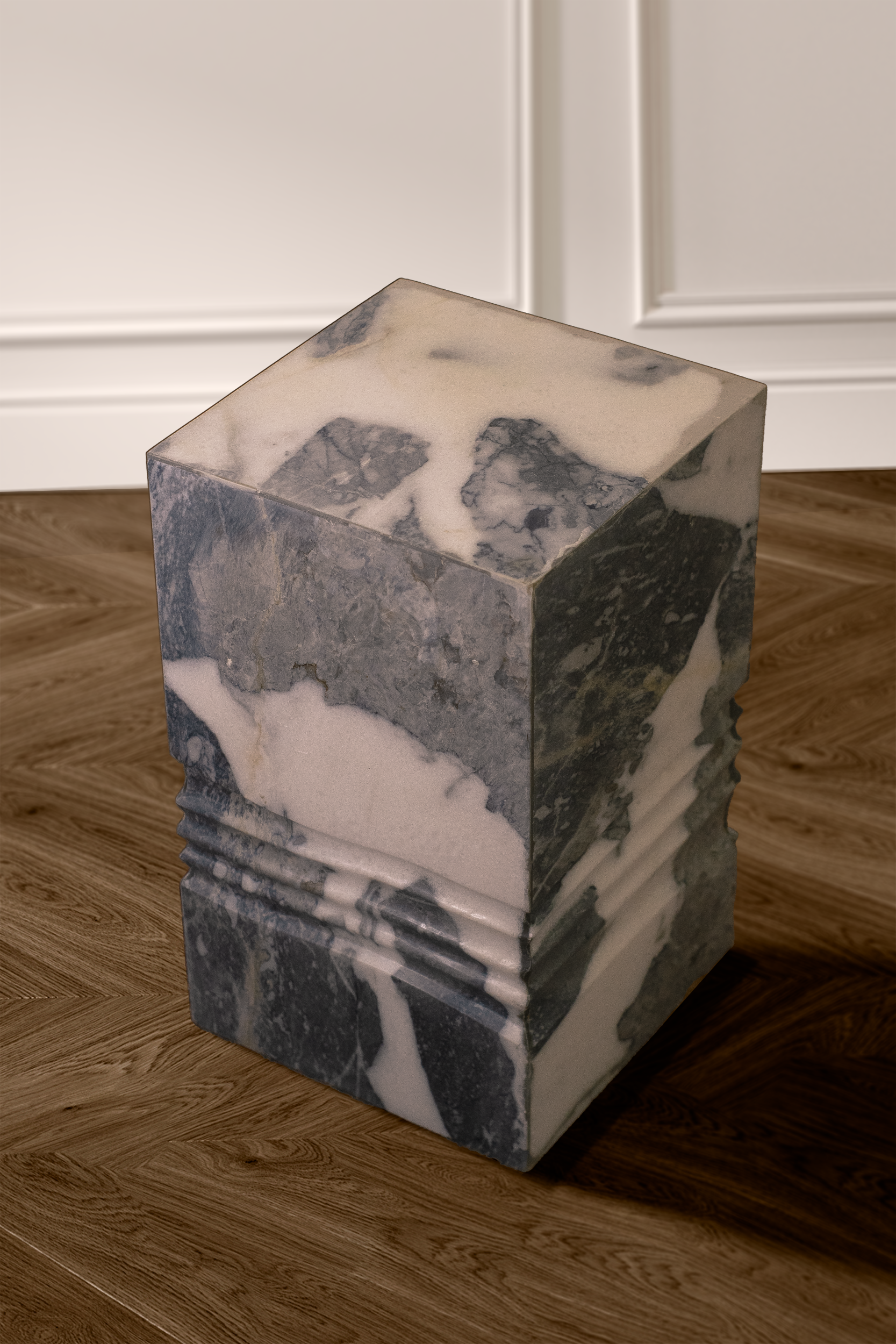 Elysian side table in white marble with grey veins showcased in a stylish living room.