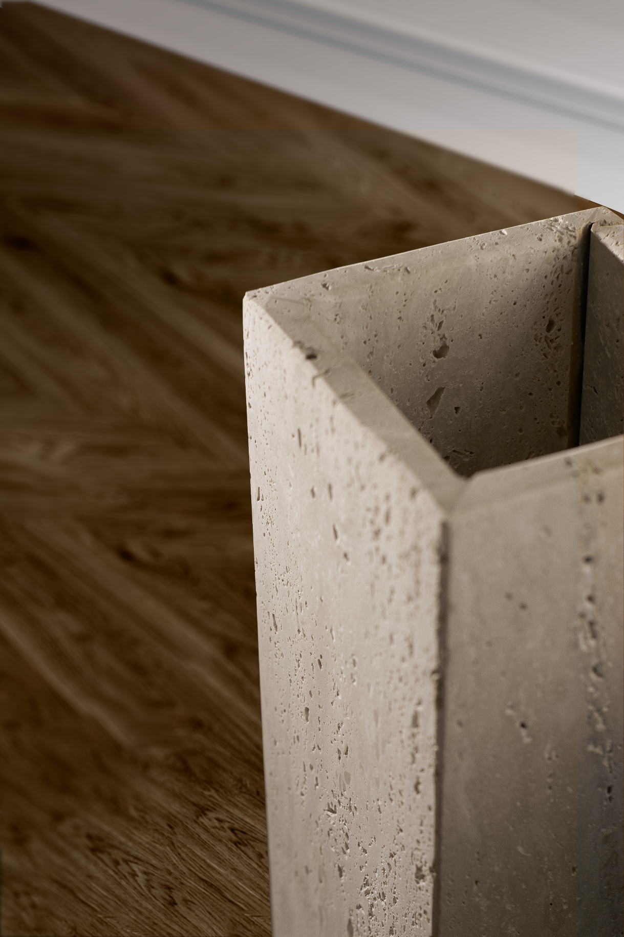 Elegant Terra vase in travertine enhancing a dining area with its commanding presence and raw finish.