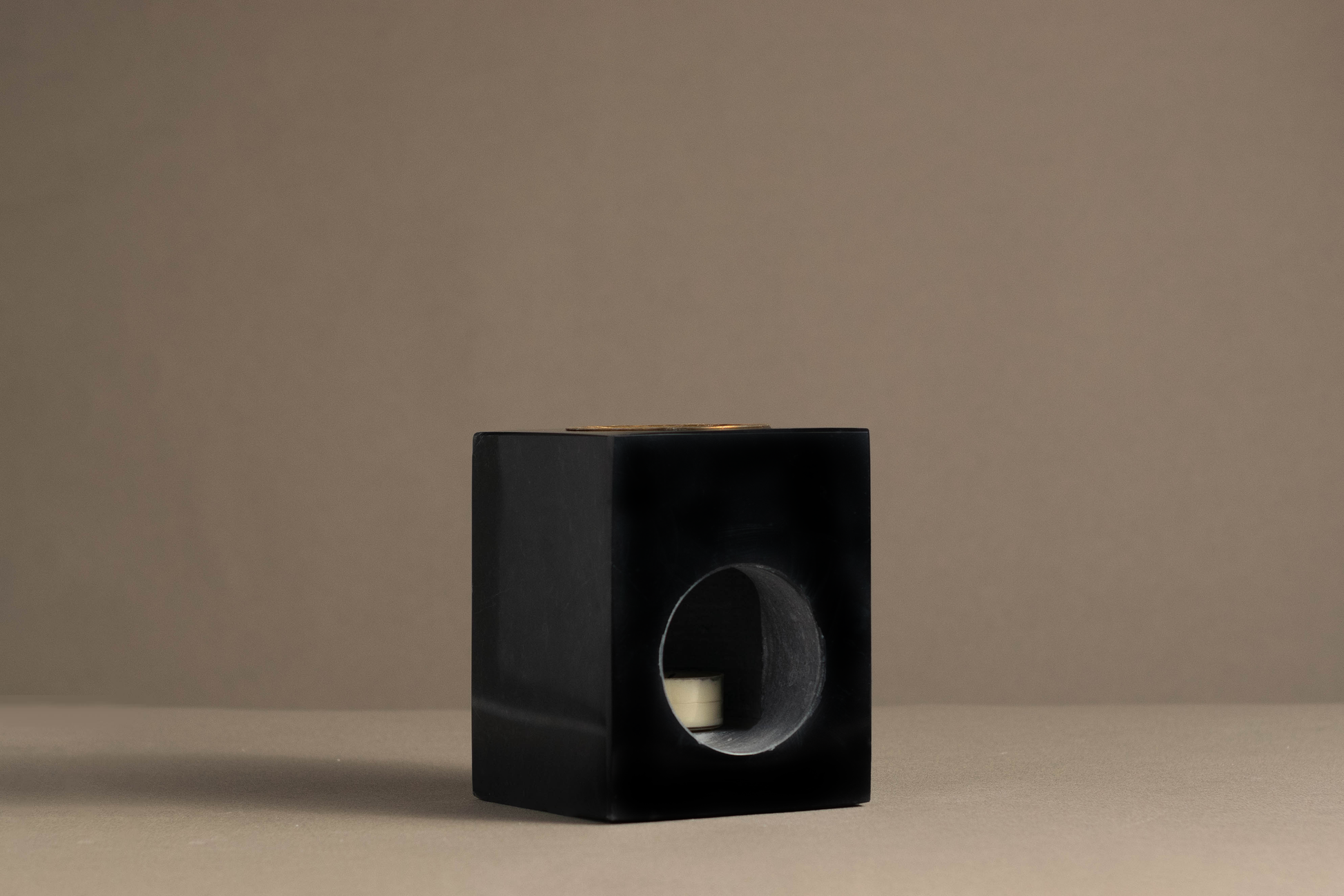 Artisan-crafted Serene Tealight Oil Burner in black marble, perfect for warming essential oils and enhancing ambiance.