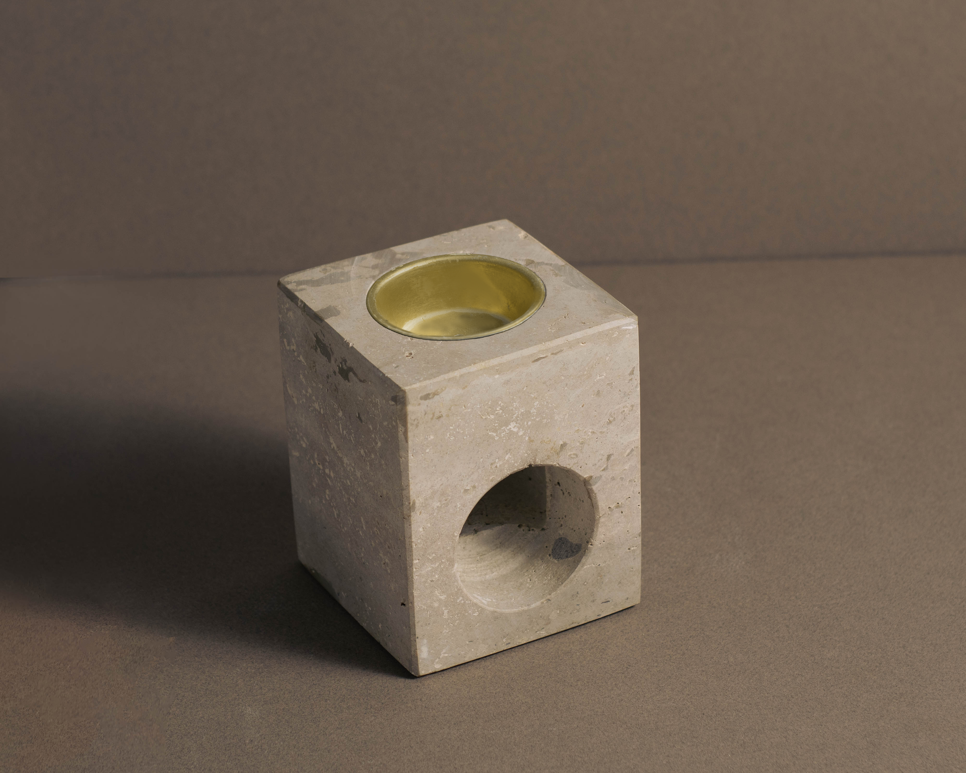 Handcrafted travertine tealight oil burner with polished finish, perfect for aromatherapy and home decor .