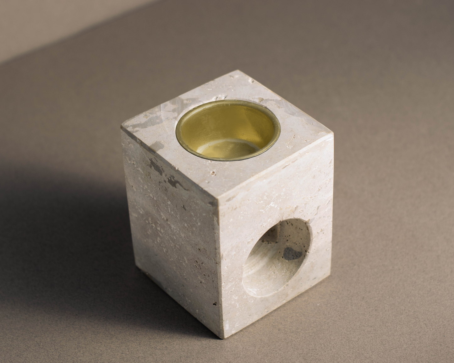 Elegant travertine stone tealight oil burner, designed to gently diffuse essential oils and create a relaxing ambiance.