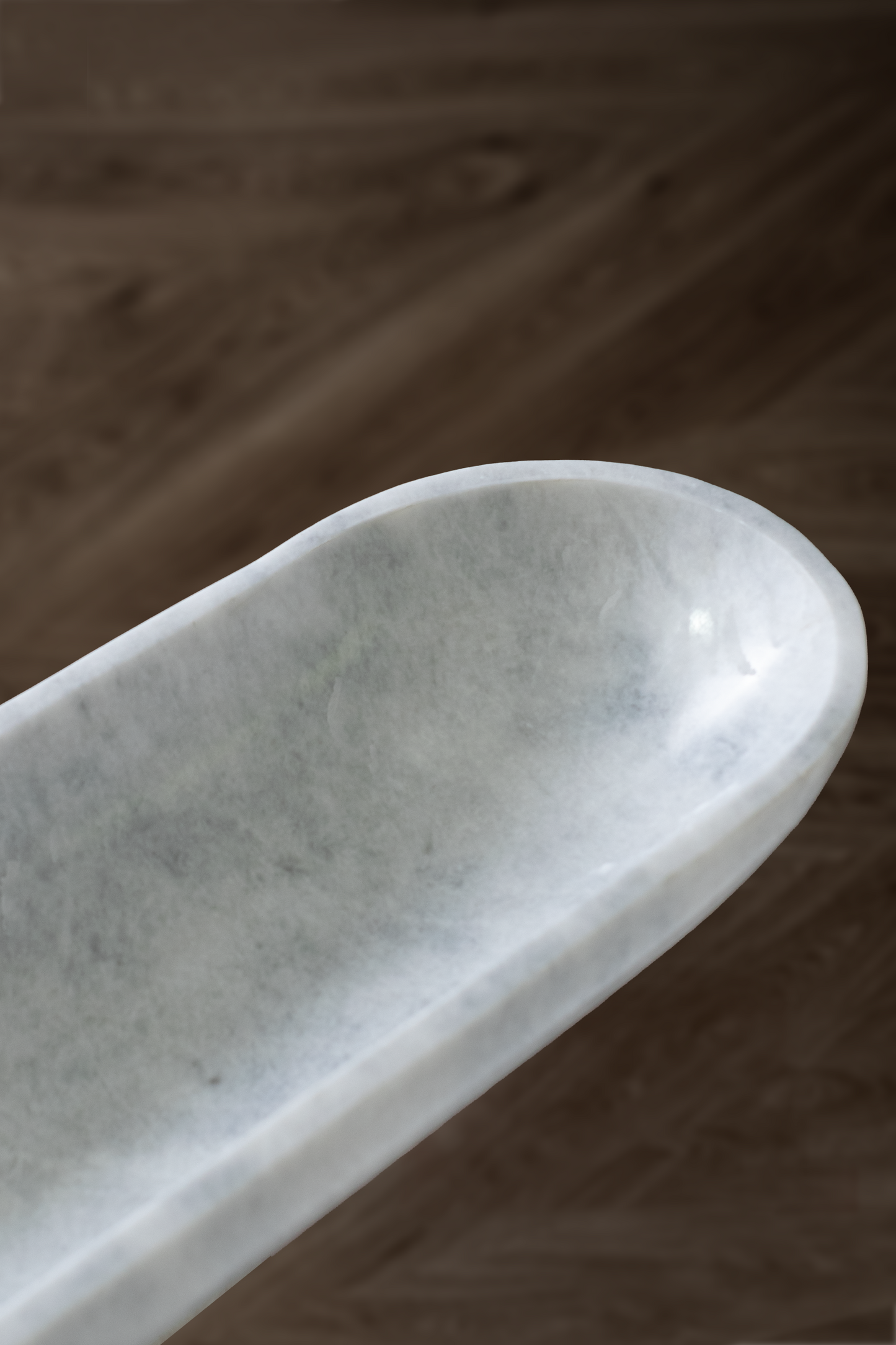 Handcrafted Serenity Oval Bowl in white marble, ideal for serving or decorative use.
