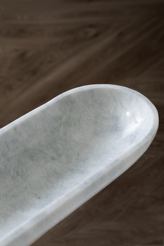 Handcrafted Serenity Oval Bowl in white marble, ideal for serving or decorative use.
