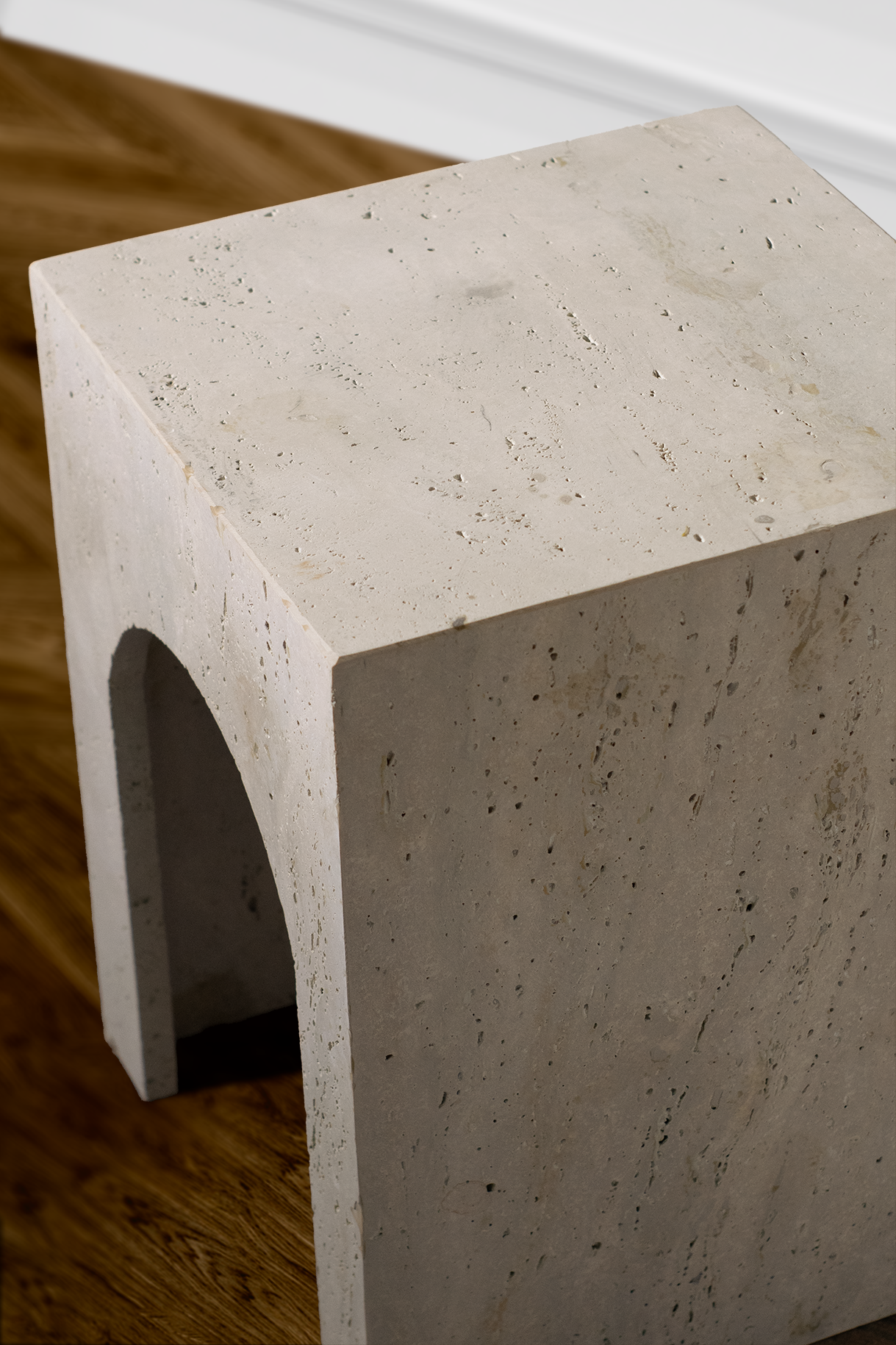 Close-up of the travertine Arcadia Side Table surface, showcasing unique natural patterns, color variations, and refined stone texture.