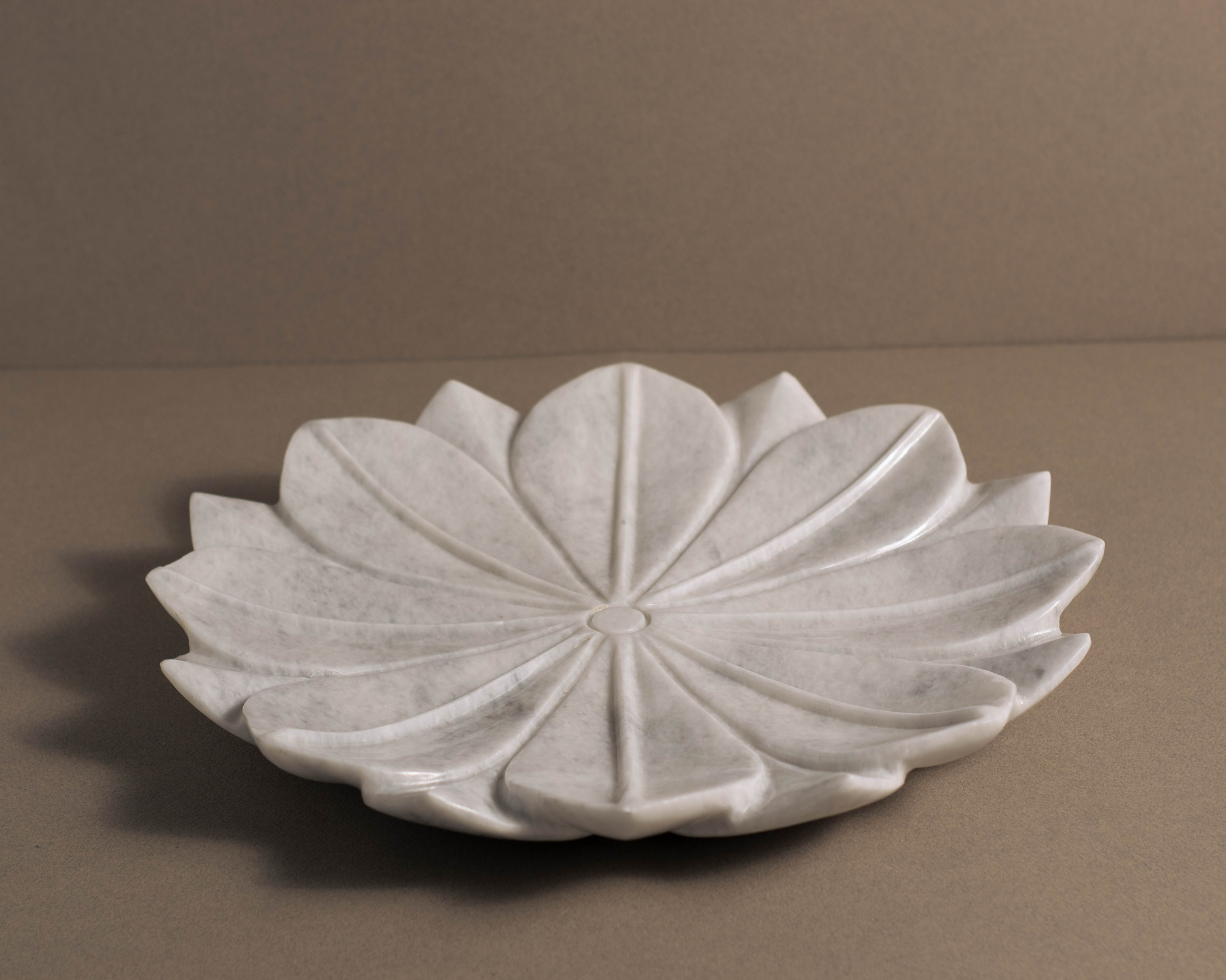 Handcrafted White Marble Charger Plate serving as a stylish base for dinner plates and decorative accents.