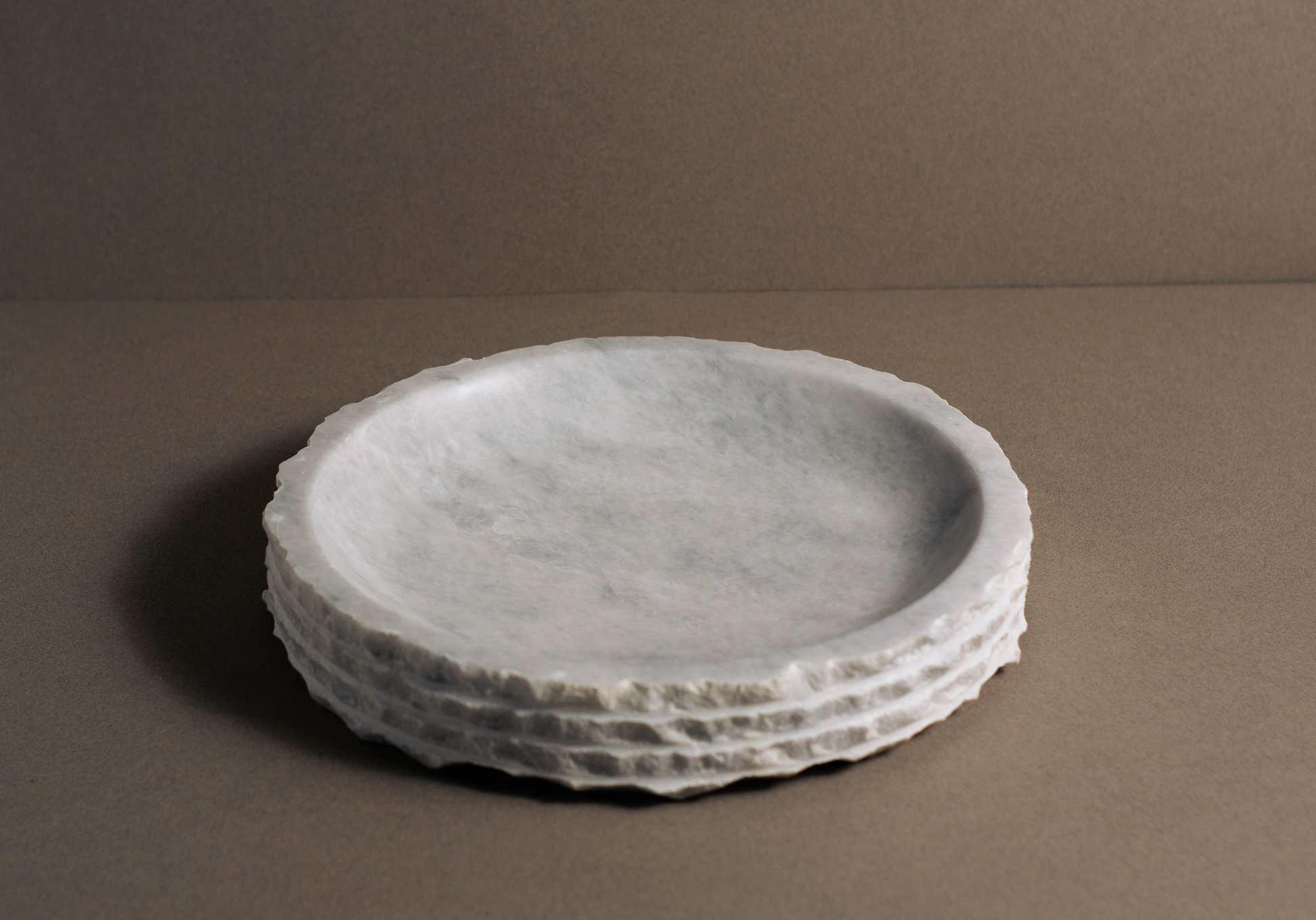 Elegant Eclipse round bowl in white marble, showcasing its luminous finish.