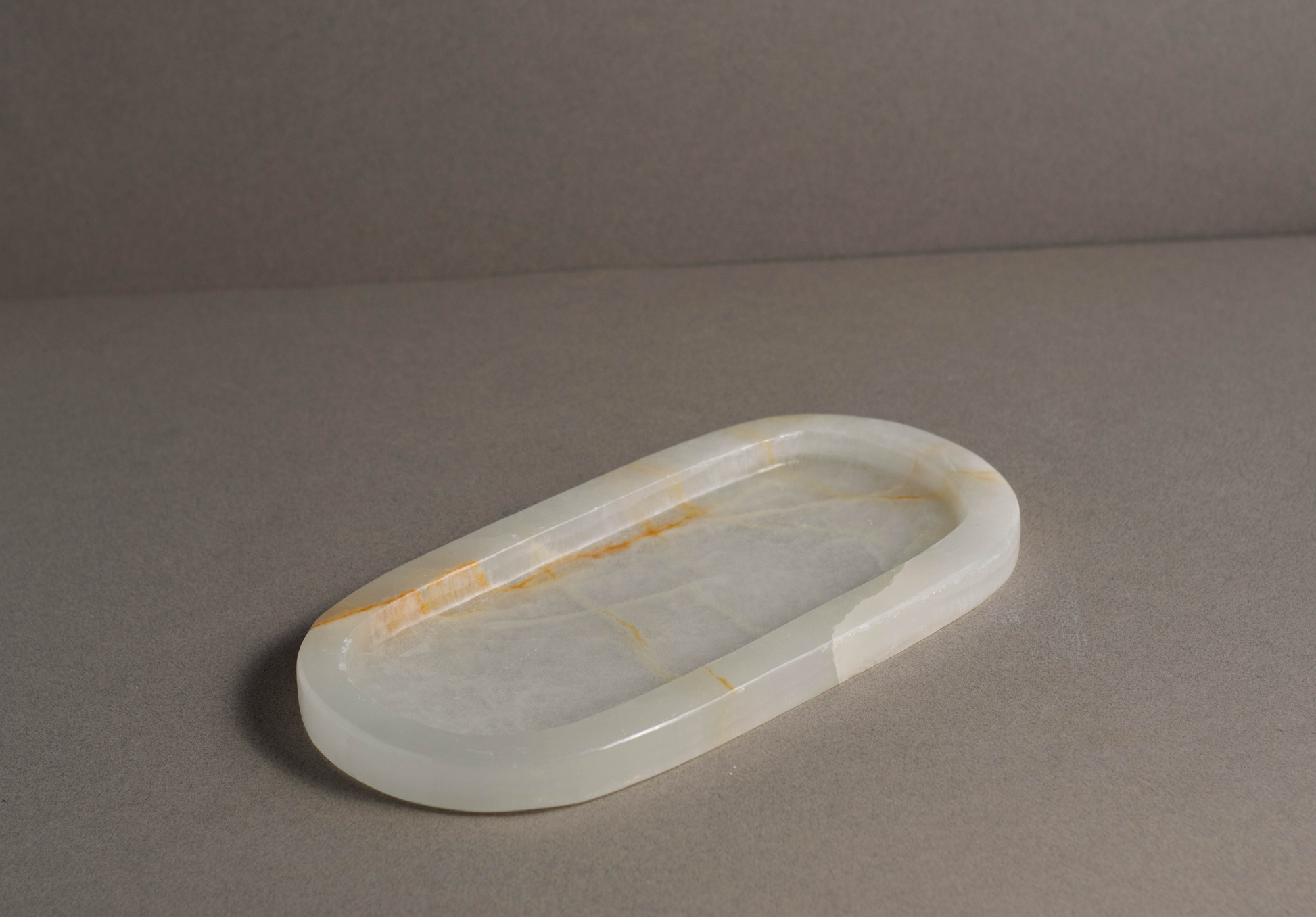 Premium white onyx Aura tray with an oval shape, perfect for organizing essentials on a tabletop or vanity.