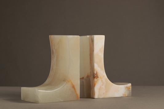 Unique Ascend bookends made from white onyx, showcasing translucent beauty and artisan craftsmanship for stylish organization.