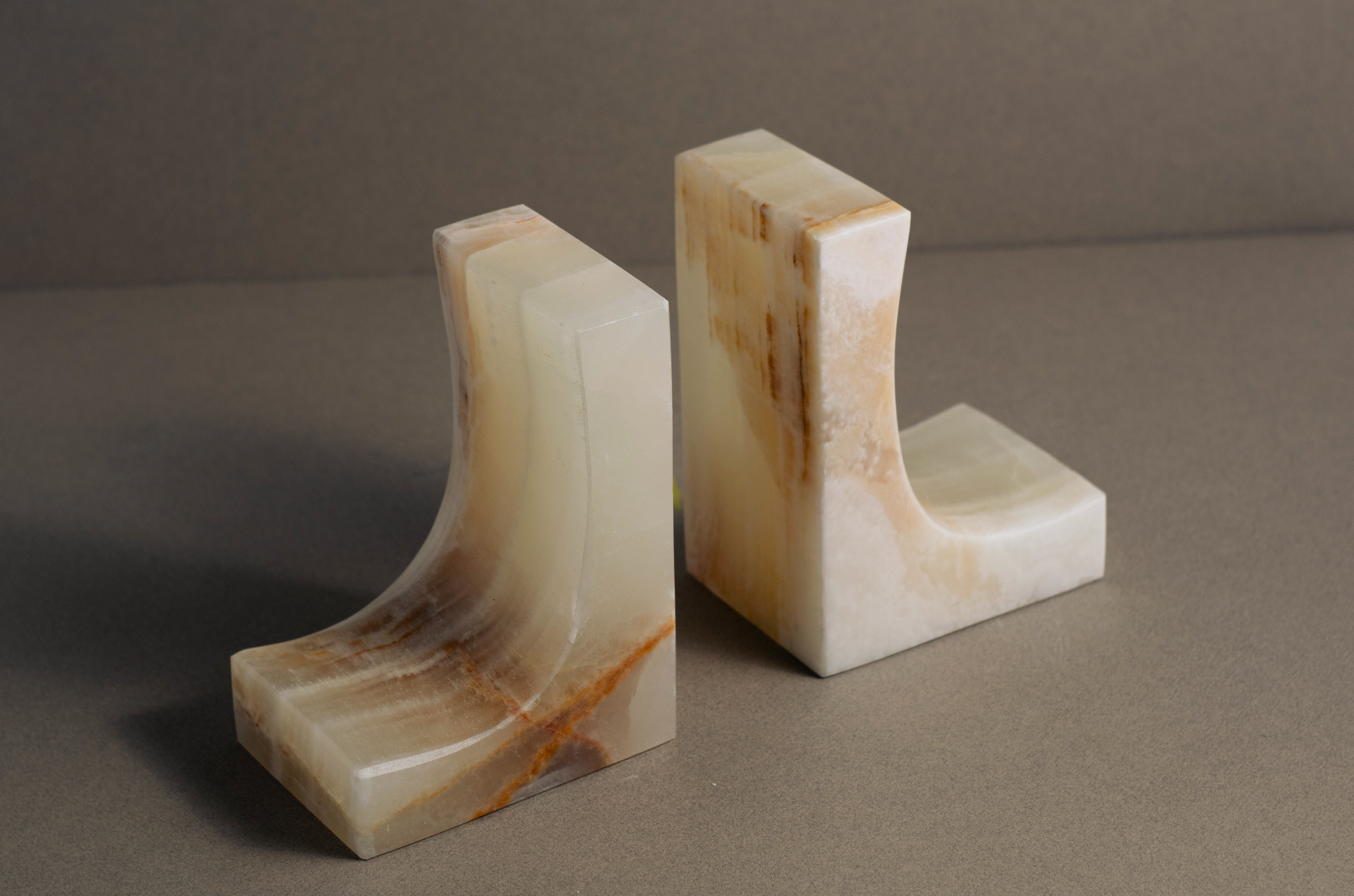 Elegant white onyx bookends, designed to support books while adding a touch of sophistication to bookshelves or desks.