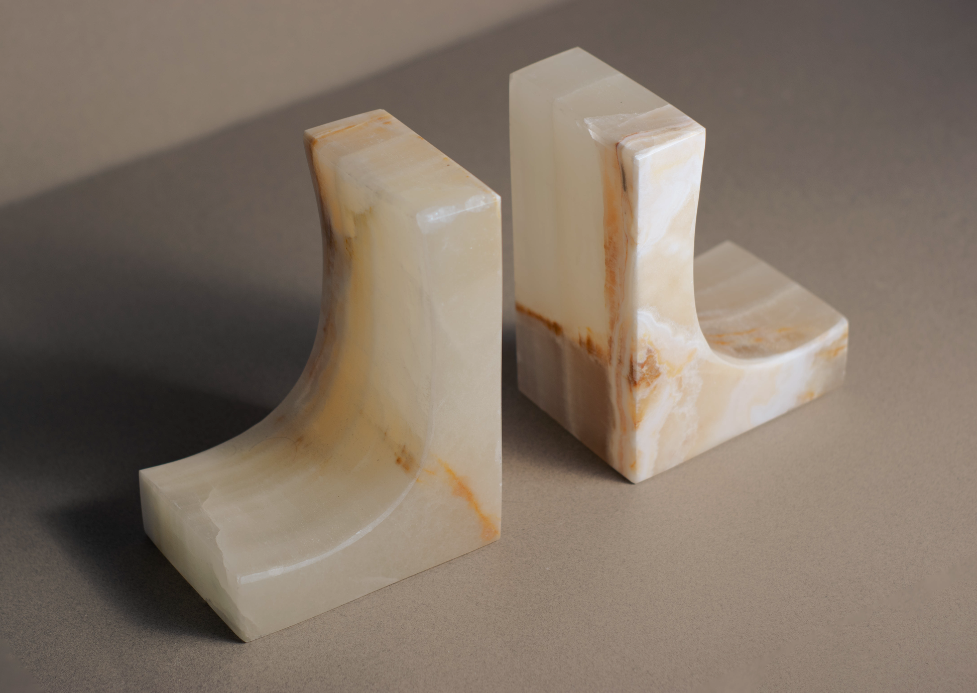 Handcrafted Ascend bookends in premium white onyx, featuring smooth surfaces and unique veined patterns for elegant decor.