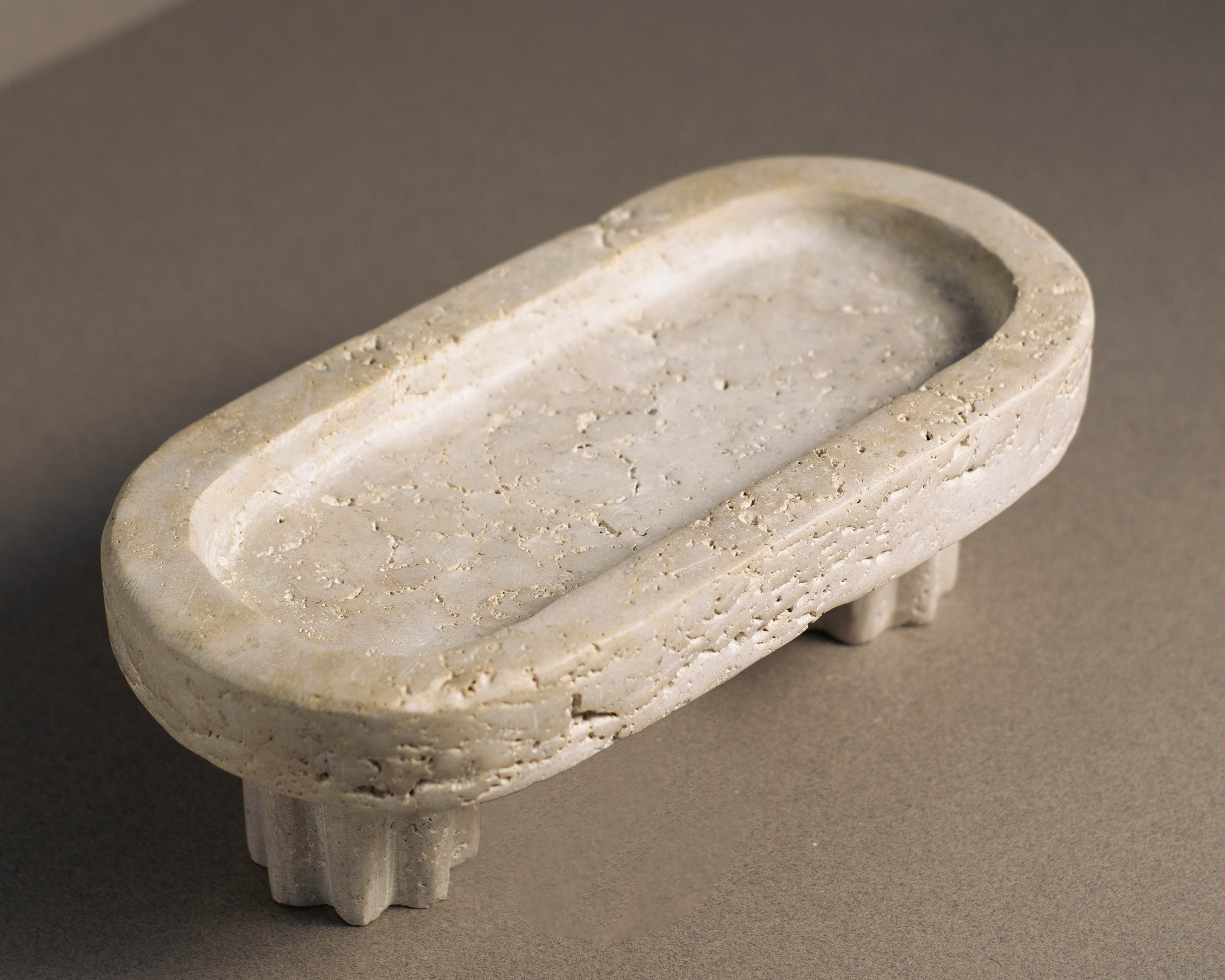 Handcrafted travertine column tray in an oval shape, featuring a smooth finish and natural textures; perfect for elegant home decor and versatile storage or display.