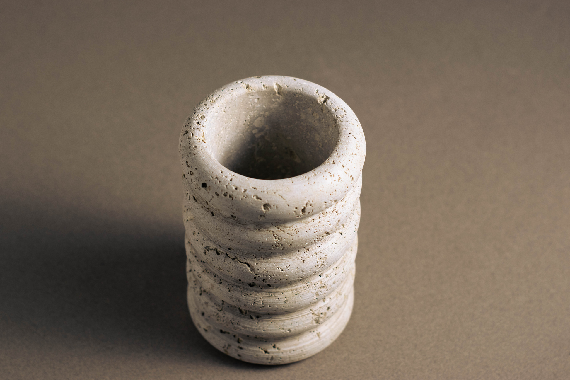 Natural stone vase featuring ocean-inspired curves, adding sophistication to home decor.