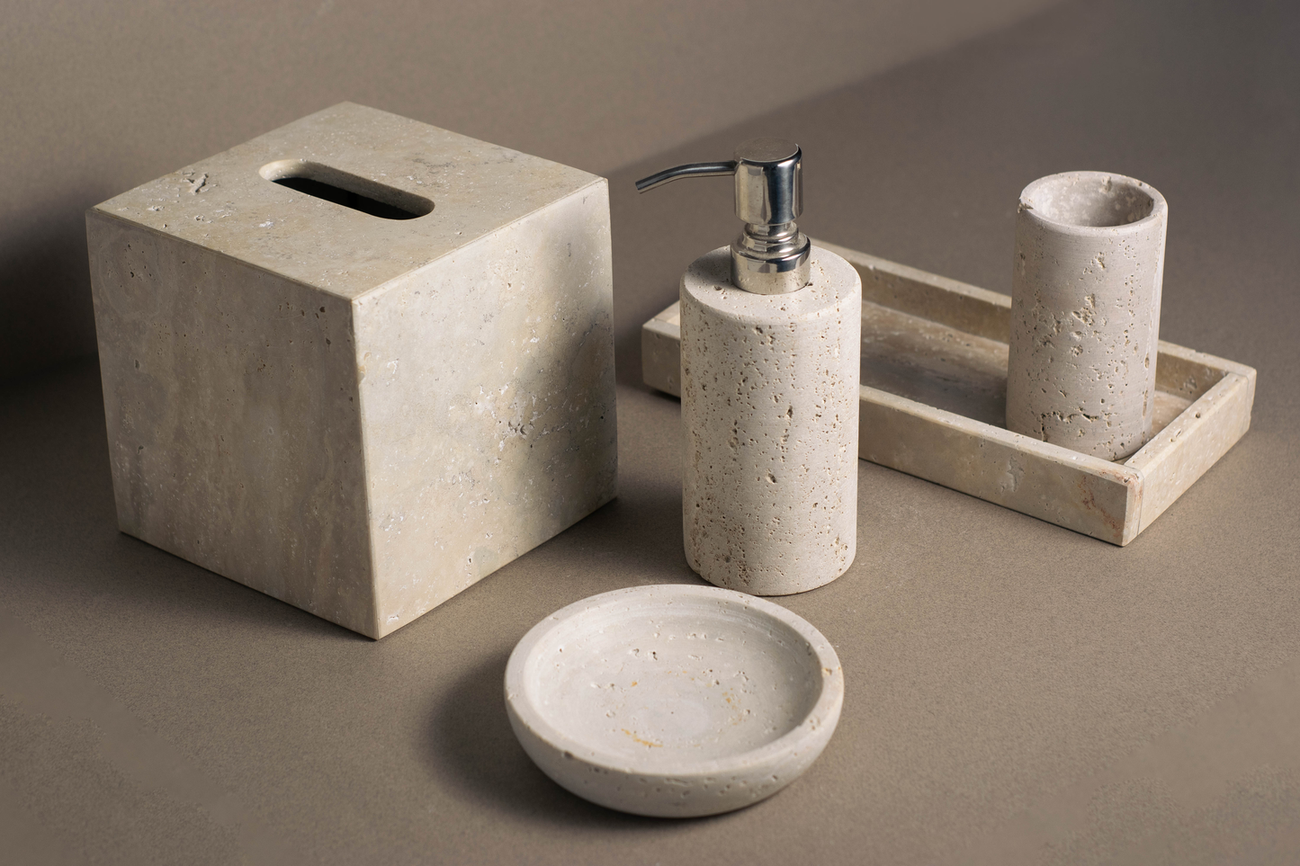 "Warm earthy tones of the travertine luxe bath collection adding sophistication to a bathroom."
