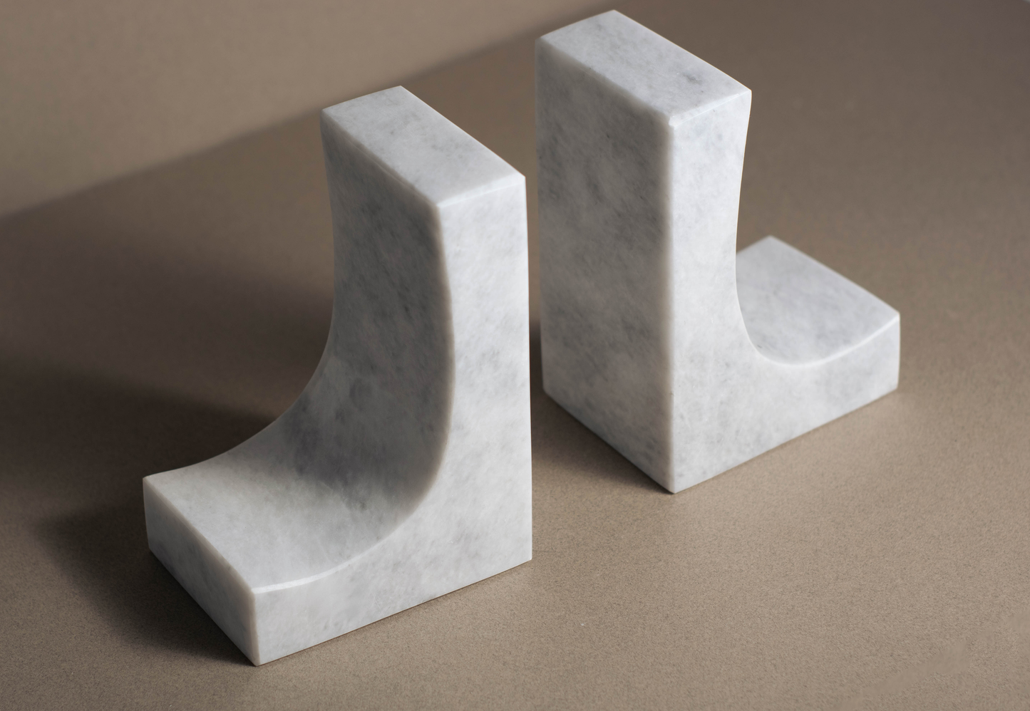 Handcrafted Ascend White Marble Bookends with polished surface and natural veining for elegant decor.