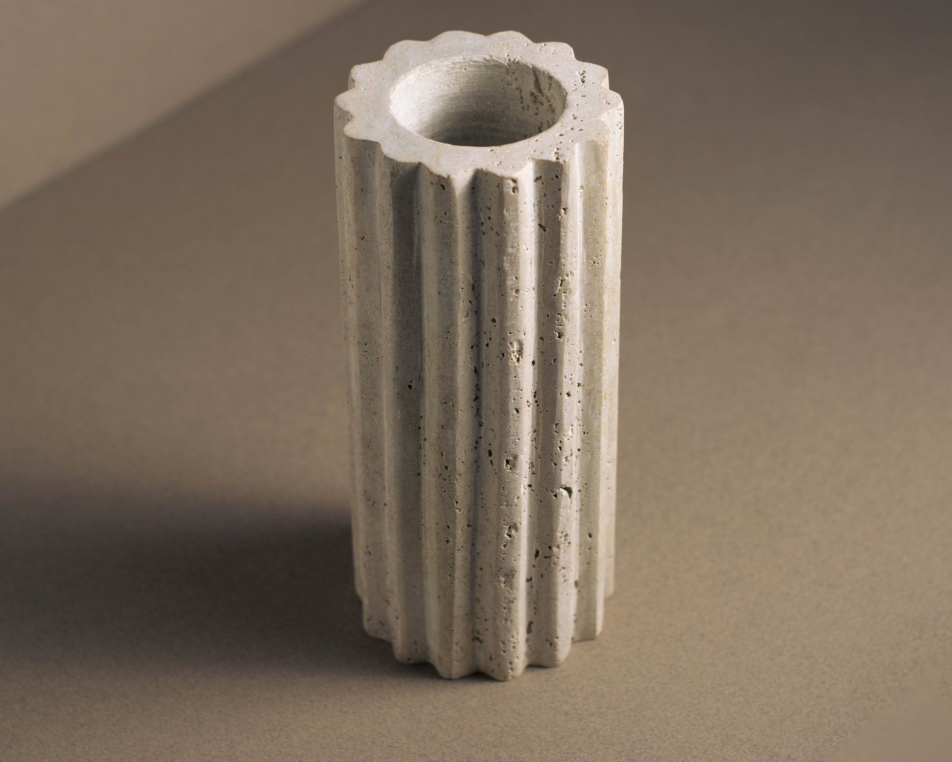 Artisan-crafted Hand-Fluted Travertine Vase, highlighting natural beauty and sophistication in any interior.