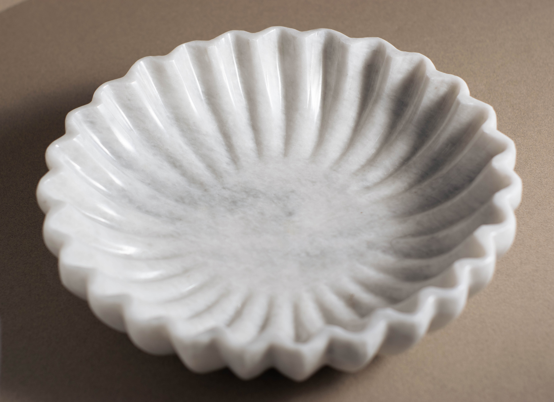 Elegant marble bowl crafted by artisans, featuring a unique coral shape and natural stone veining.