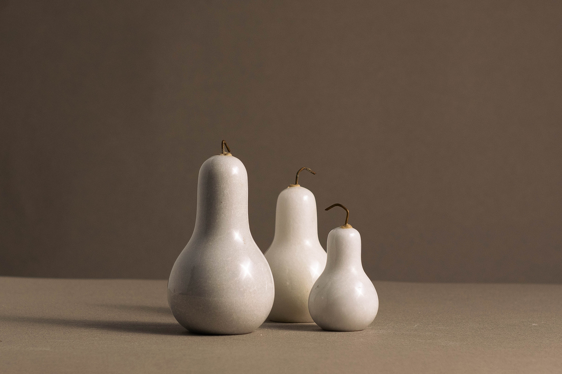 "Stylish trio of pear sculptures made from premium white marble, adding a touch of luxury to any room."