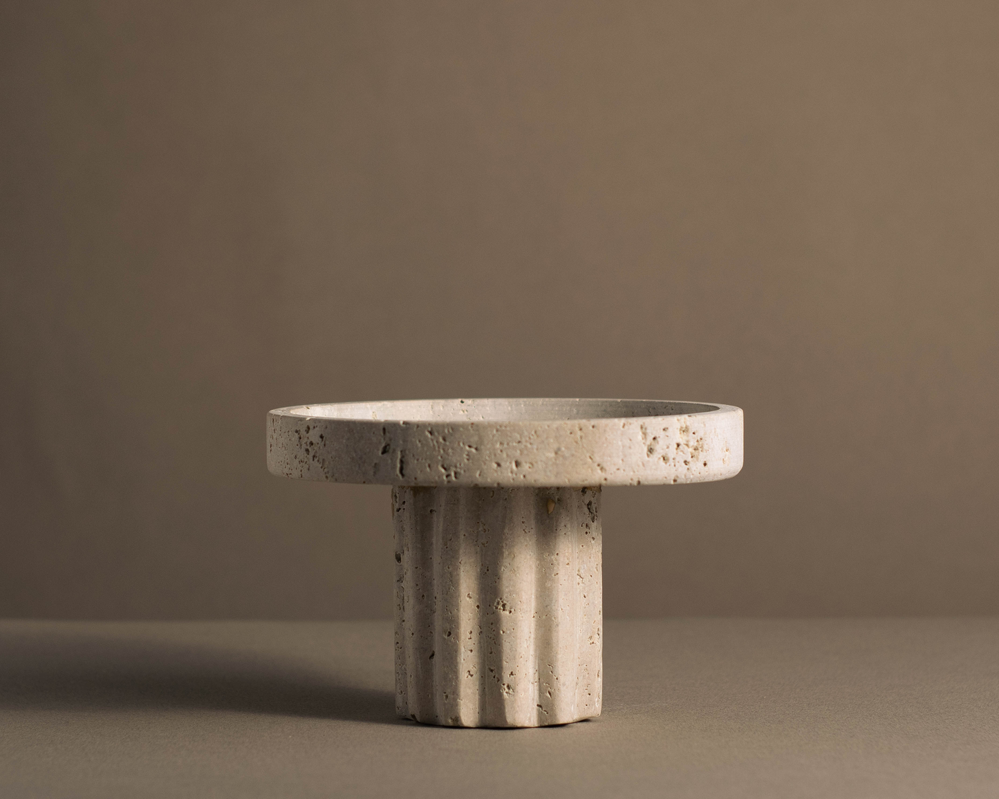 Stylish round column tray in high-quality travertine, perfect for serving and displaying items in any home decor.